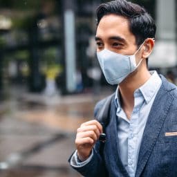 Man with a hearing aid wearing a mask.