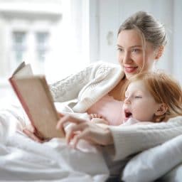 Mother reading a story with her daughter.